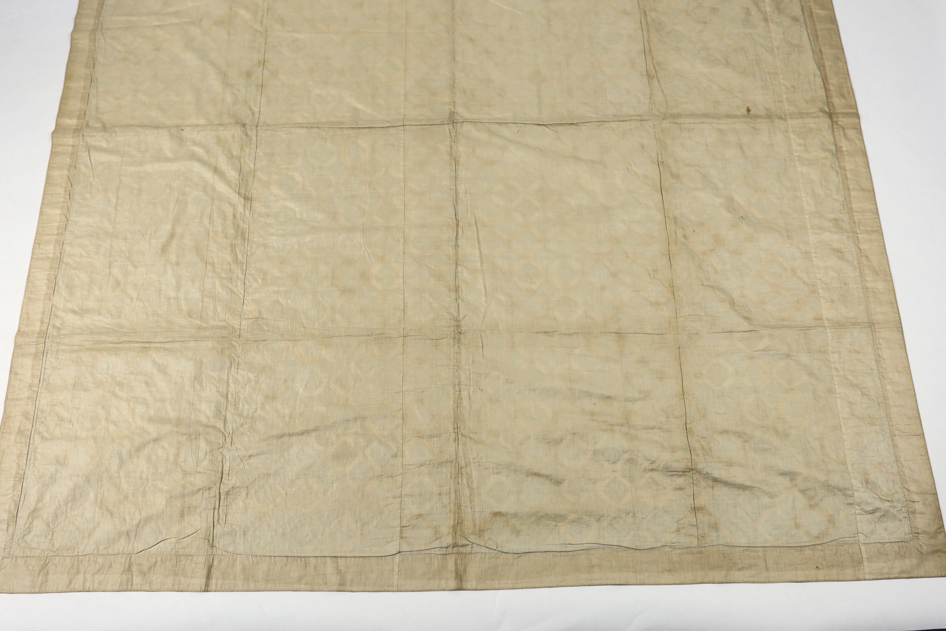 A handsome 19th century silk patch worked quilt, worked in repeating octagon shapes, in a large selection of 19th century printed and woven brocaded silks on a black and brown velvet background, edged with a 19th century